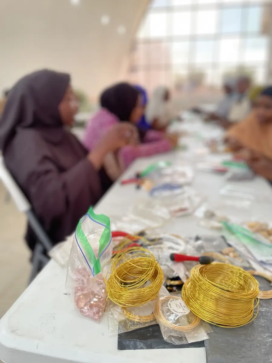 Wire coils, beads and pliers on the training bench